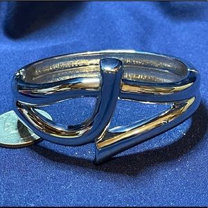 Bracelet. Silver tone cuff with hinge.